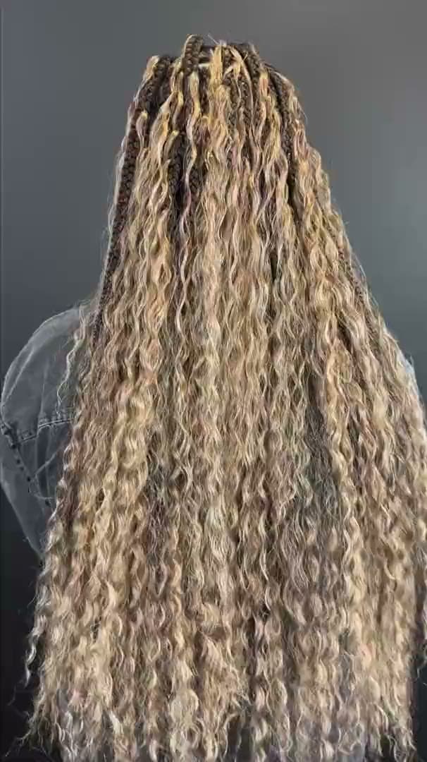 Full-length blonde braids with loose curled ends, seen from behind