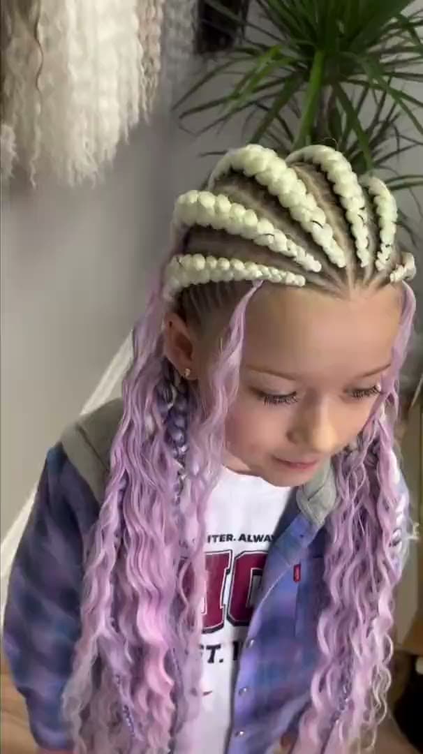 A child in long pastel lilac braids finished in loose curls