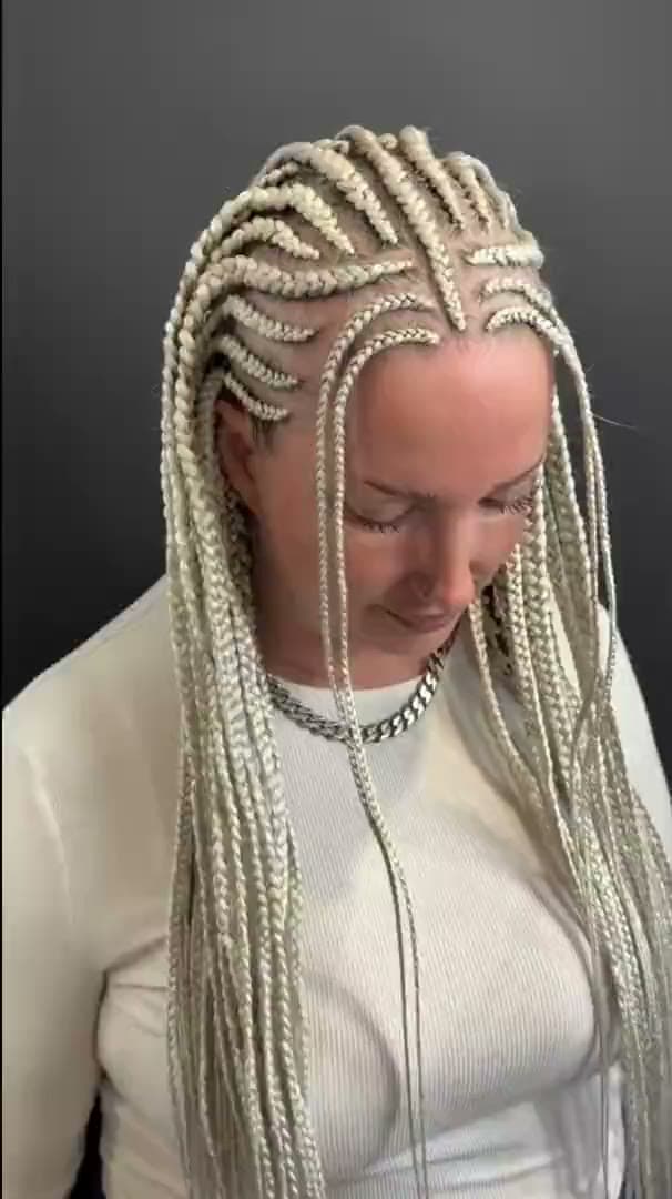 Platinum blonde braids braided close to the scalp and falling to the waist