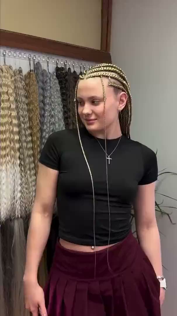 Blonde braids taken straight back from the hairline, seen from the front